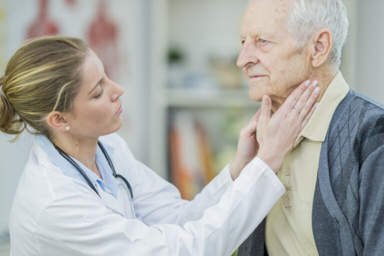 doctor checking old man's lymph nodes