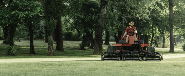 A man mowing a golf course